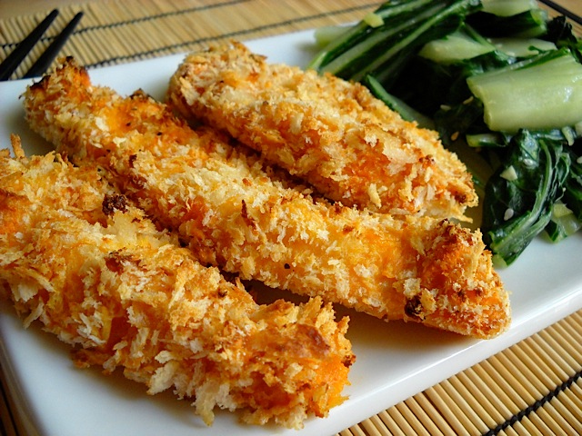 Sriracha Chicken Strips plated on white plate with greens 